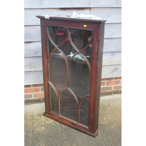 443 - A Georgian mahogany corner cabinet enclosed Gothic lattice glazed panel door, 28