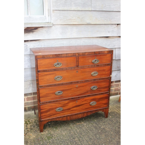 444 - A Georgian mahogany chest of two short and three long graduated drawers with oval brass handles, on ... 