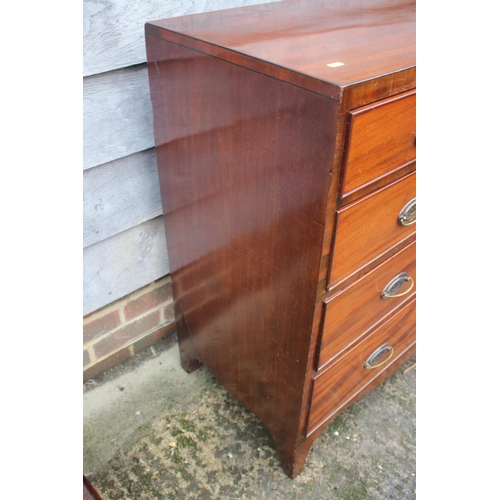 444 - A Georgian mahogany chest of two short and three long graduated drawers with oval brass handles, on ... 