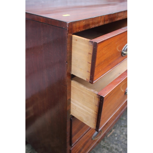 444 - A Georgian mahogany chest of two short and three long graduated drawers with oval brass handles, on ... 