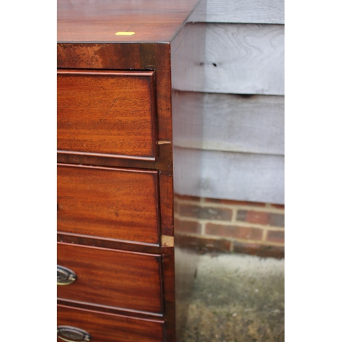 444 - A Georgian mahogany chest of two short and three long graduated drawers with oval brass handles, on ... 