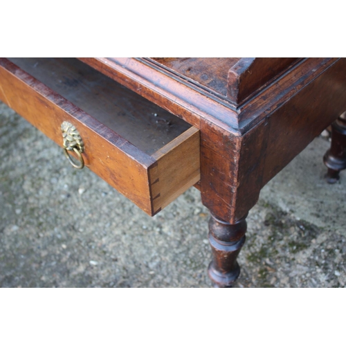 448 - An early 19th century mahogany shaped back waterfall bookcase, fitted two drawers, on turned and tap... 