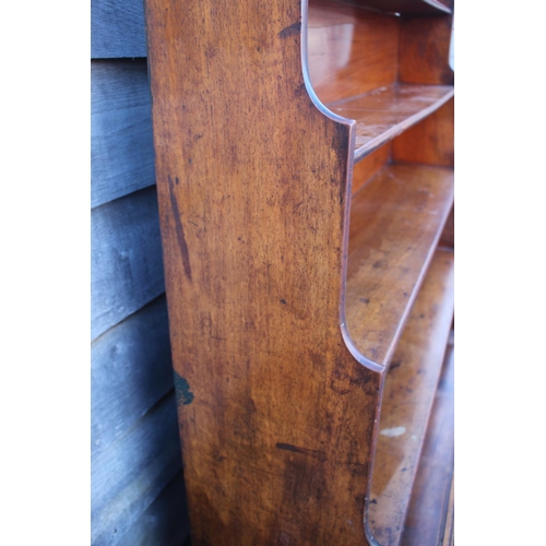 448 - An early 19th century mahogany shaped back waterfall bookcase, fitted two drawers, on turned and tap... 