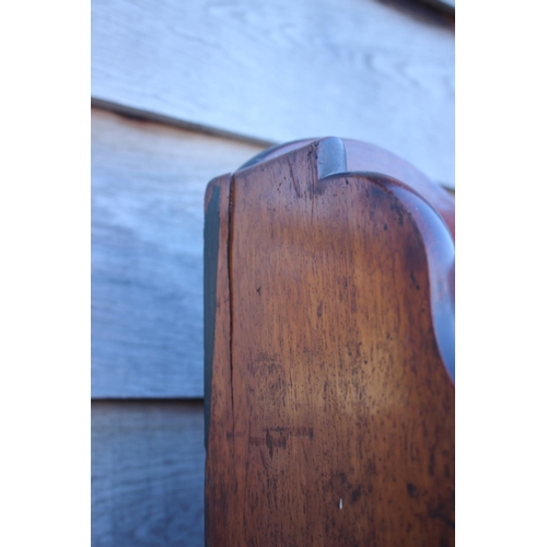 448 - An early 19th century mahogany shaped back waterfall bookcase, fitted two drawers, on turned and tap... 