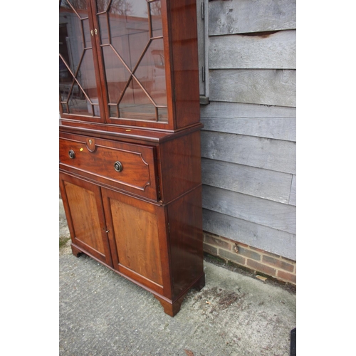 450 - A 19th century mahogany secretaire bookcase, the upper section enclosed lattice glazed doors over fi... 