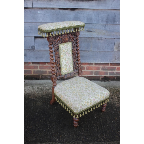 451 - A late 19th century carved oak prie-dieu chair of Restoration design with Jacquard seat and back pan... 