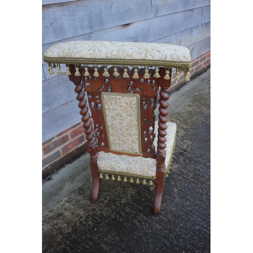 451 - A late 19th century carved oak prie-dieu chair of Restoration design with Jacquard seat and back pan... 