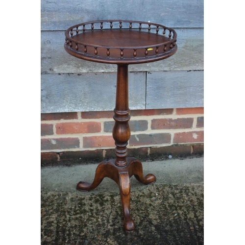 452 - A walnut wine table with galleried top, on turned column and tripod splay support, 15