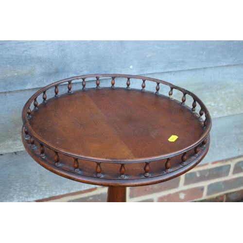 452 - A walnut wine table with galleried top, on turned column and tripod splay support, 15