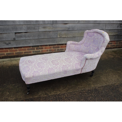 453 - A late Victorian day bed, upholstered in a cut velvet, on turned and castored supports, 60