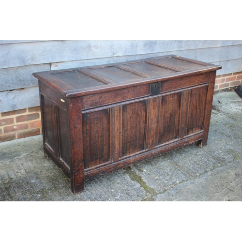 457 - An early 18th century oak four panel front coffer with hinged lid, on stile supports, 53