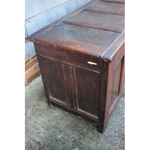 457 - An early 18th century oak four panel front coffer with hinged lid, on stile supports, 53