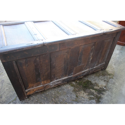 457 - An early 18th century oak four panel front coffer with hinged lid, on stile supports, 53