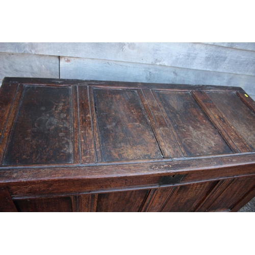 457 - An early 18th century oak four panel front coffer with hinged lid, on stile supports, 53