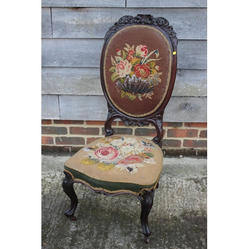 460 - A 19th century carved rosewood low seat nursing chair with needlepoint seat and back panels, on cabr... 