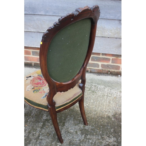 460 - A 19th century carved rosewood low seat nursing chair with needlepoint seat and back panels, on cabr... 