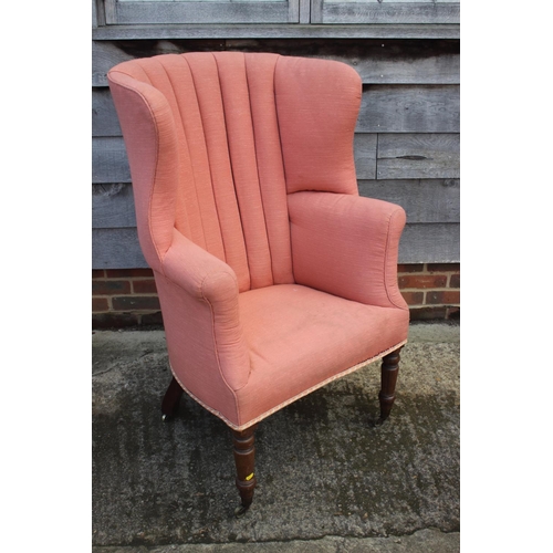 462 - A hall porter's Georgian wing armchair, on turned and castored supports