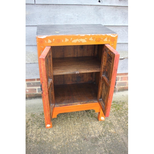 466 - A Chinese red lacquered butterfly decorated cupboard, on stile supports, 22