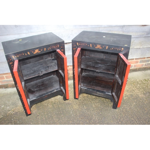 467 - A pair of red lacquered and black butterfly decorated side cupboards, 22 1/2