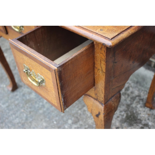 474 - A Georgian provincial oak and mahogany banded lowboy, fitted one shallow and two deep drawers, on ca... 