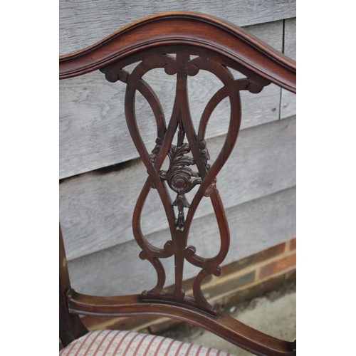 476 - A late 19th century carved pierced walnut elbow chair with padded arms and seat, on cabriole support... 