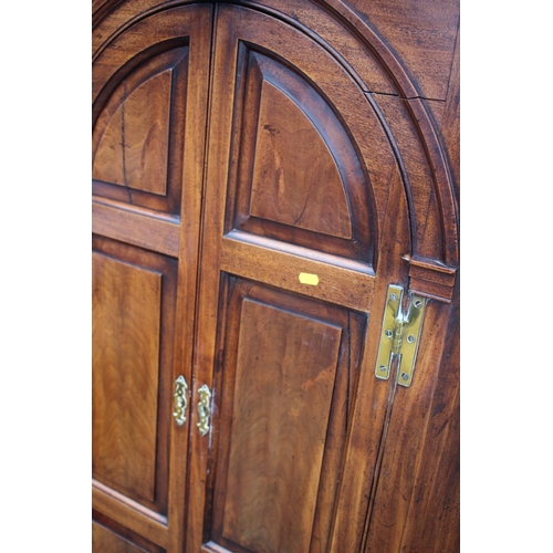 477 - An 18th century mahogany corner cupboard with dental cornice over arch top panelled doors, 38