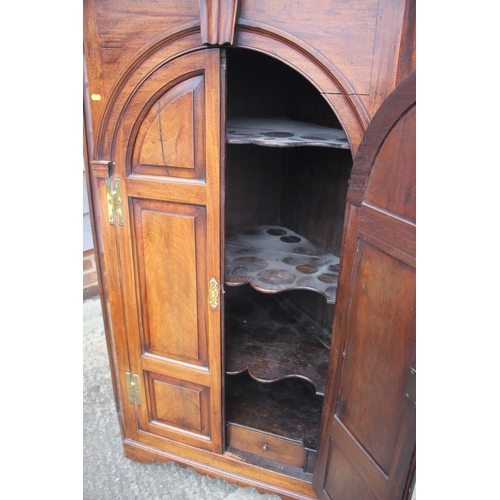 477 - An 18th century mahogany corner cupboard with dental cornice over arch top panelled doors, 38