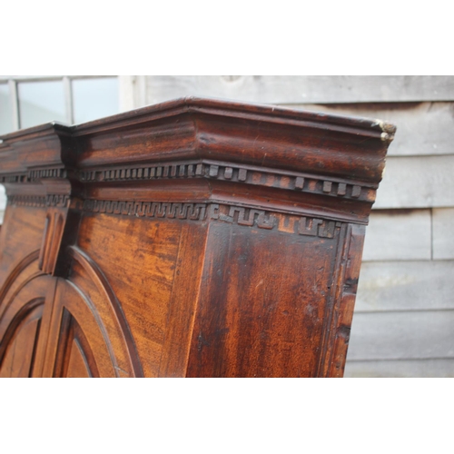 477 - An 18th century mahogany corner cupboard with dental cornice over arch top panelled doors, 38