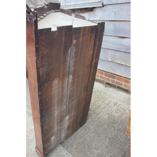 477 - An 18th century mahogany corner cupboard with dental cornice over arch top panelled doors, 38