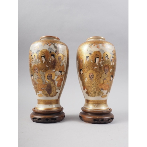 81 - A pair of Satsuma figure decorated oviform vases with signature marks to base, 7