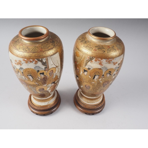 81 - A pair of Satsuma figure decorated oviform vases with signature marks to base, 7