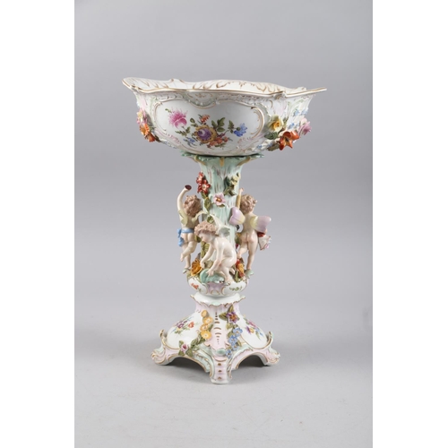 11 - A German porcelain table centre with figure support and floral decoration, 16 inches high