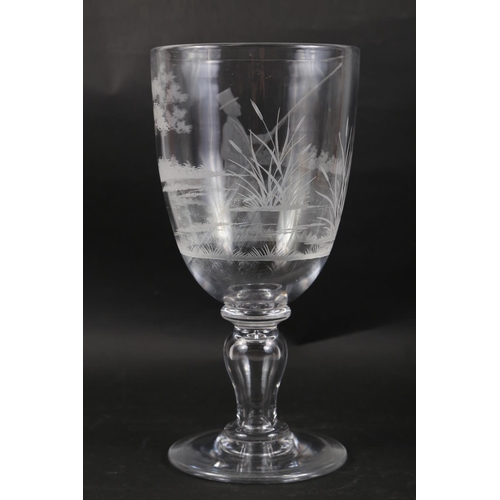 47 - An early 19th century glass goblet with engraved fisherman decoration, 11 1/2