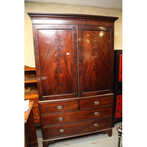 480 - An early 19th century figured mahogany linen press, the upper section fitted trays enclosed two pane... 