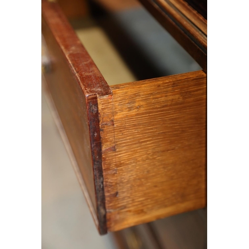 480 - An early 19th century figured mahogany linen press, the upper section fitted trays enclosed two pane... 