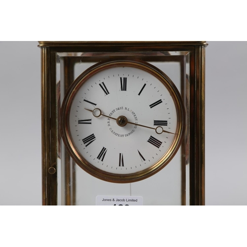 123 - A 19th century brass and four glass mantel clock with white enamel dial and Roman numerals, 10