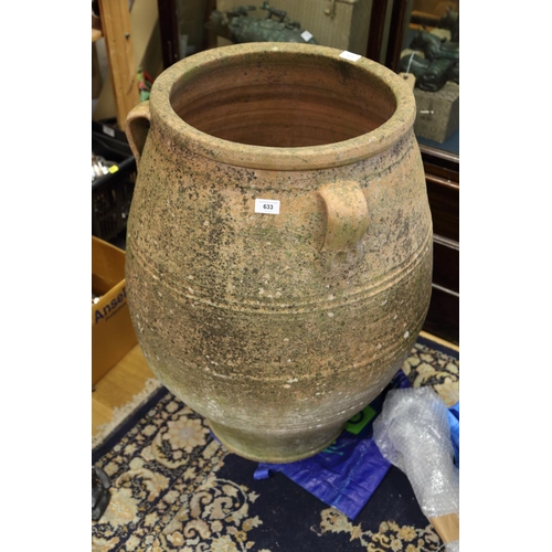 633 - A Greek terracotta jar with three handles, 33 1/2