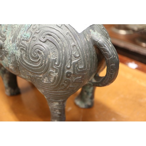 115 - A Chinese bronze limited edition ritual vessel, formed as a water buffalo with engraved archaic deco... 