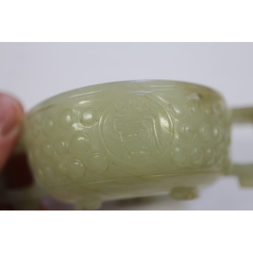 110 - A carved jade two-handled vessel, 4 1/8