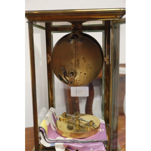 123 - A 19th century brass and four glass mantel clock with white enamel dial and Roman numerals, 10