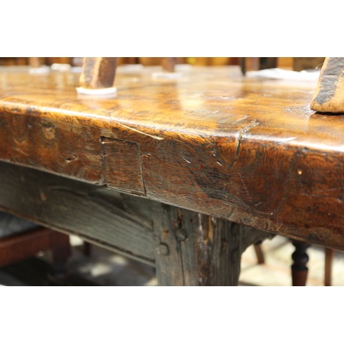 449 - An antique elm slab top refectory table, on chamfered and stretchered supports, top 84