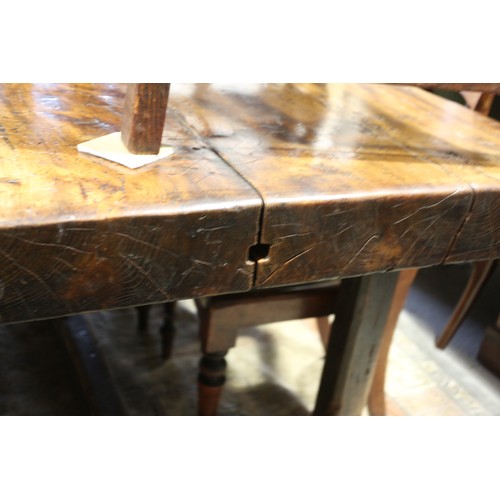 449 - An antique elm slab top refectory table, on chamfered and stretchered supports, top 84