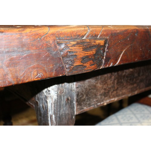 449 - An antique elm slab top refectory table, on chamfered and stretchered supports, top 84