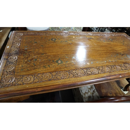 585 - A carved sheesham brass and copper inlaid coffee table, on cabriole supports, 48