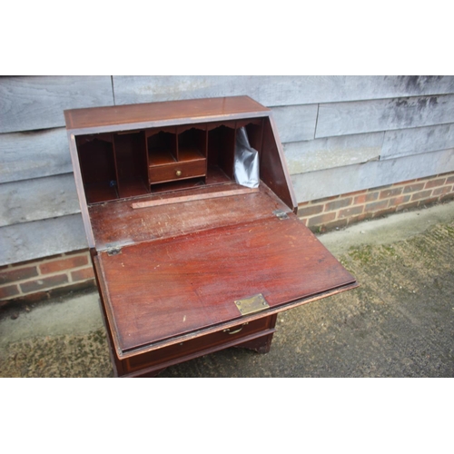 588 - An early 20th century walnut and satinwood banded fall front bureau with fitted interior over three ... 