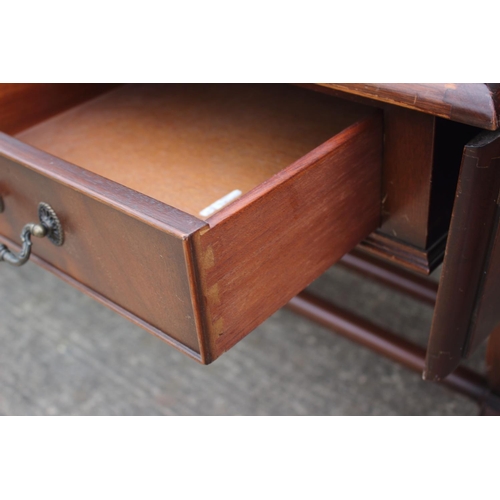 605 - A mahogany sofa table/desk with leather inset top, fitted three drawers over lyre end supports unite... 