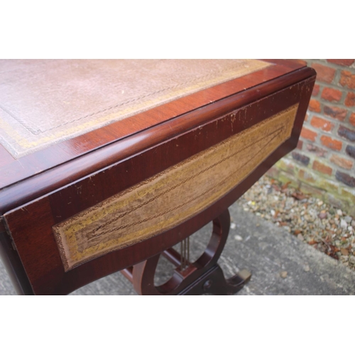 605 - A mahogany sofa table/desk with leather inset top, fitted three drawers over lyre end supports unite... 