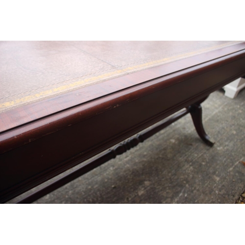 605 - A mahogany sofa table/desk with leather inset top, fitted three drawers over lyre end supports unite... 