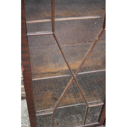 638 - A mahogany bookcase enclosed two astragal moulded glass panel doors, on ogee bracket feet, 37 wide x... 