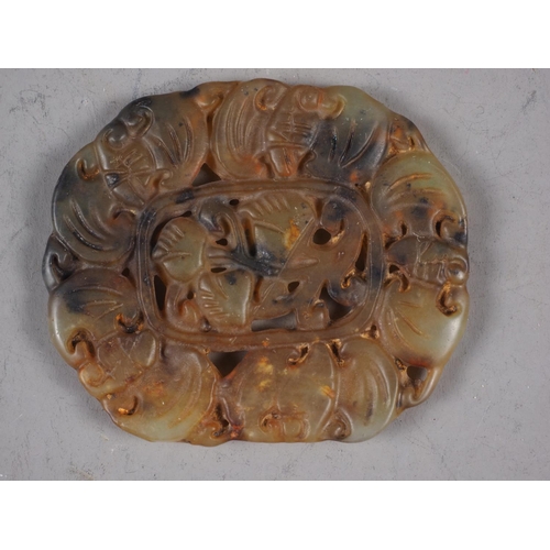 109 - A Chinese carved jade roundel with bats and flowers, 2 1/4